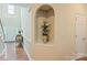 Hallway featuring an alcove display and hardwood floors at 7245 Willow Brook Ct, Denver, NC 28037