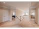 Hallway with carpeted floors, access to bedrooms, and natural light from a chandelier at 7245 Willow Brook Ct, Denver, NC 28037