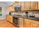 Well-equipped kitchen with stainless steel appliances and a granite countertop, perfect for cooking at 7245 Willow Brook Ct, Denver, NC 28037