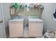 Functional laundry area with washer, dryer, and shelving for storage and organization at 7245 Willow Brook Ct, Denver, NC 28037