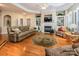 Elegant living room with hardwood floors, fireplace, built-in bookshelves and ample seating at 7245 Willow Brook Ct, Denver, NC 28037