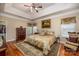 Beautiful main bedroom featuring a tray ceiling, rich hardwood floors, and elegant furnishings at 7245 Willow Brook Ct, Denver, NC 28037