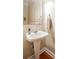 Charming powder room with pedestal sink, decorative mirror, and classic finishes at 7245 Willow Brook Ct, Denver, NC 28037