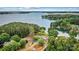 Lakefront home with lush trees, private access to the water, and mature landscaping throughout the property at 8218 Bright Water Ln, Denver, NC 28037
