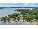 Stunning aerial view of a waterfront home with a private dock and beautiful landscaping at 8218 Bright Water Ln, Denver, NC 28037