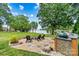 Backyard patio with outdoor kitchen and lake views; perfect for entertaining or relaxing outdoors at 8218 Bright Water Ln, Denver, NC 28037