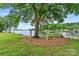 Lush backyard leading to a serene lake with a relaxing hammock and mature trees for shade at 8218 Bright Water Ln, Denver, NC 28037