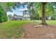 Expansive backyard featuring mature trees, a hammock, and a charming view of the home at 8218 Bright Water Ln, Denver, NC 28037
