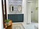 Stylishly decorated bathroom featuring a double sink vanity and a tiled shower at 8218 Bright Water Ln, Denver, NC 28037