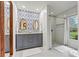 Stylishly renovated bathroom featuring a double vanity with grey cabinets and a glass-enclosed shower at 8218 Bright Water Ln, Denver, NC 28037
