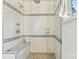 Beautiful walk-in shower featuring tiled walls and floor, a built-in seat, and modern fixtures at 8218 Bright Water Ln, Denver, NC 28037
