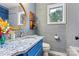 Updated bathroom with modern granite vanity, stylish fixtures, and a round mirror at 8218 Bright Water Ln, Denver, NC 28037
