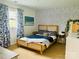 Bedroom featuring patterned wall, a bed, and a small desk with mirror at 8218 Bright Water Ln, Denver, NC 28037