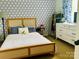Comfortable bedroom featuring trendy wallpaper and a well-lit closet area at 8218 Bright Water Ln, Denver, NC 28037