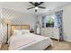 Bright bedroom with patterned accent wall, neutral carpet, and a window with blue curtains at 8218 Bright Water Ln, Denver, NC 28037