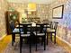 Cozy dining room featuring floral wallpaper, a rustic table, and classic wooden chairs at 8218 Bright Water Ln, Denver, NC 28037