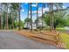 Charming white home with a two car garage nestled among mature trees and well-maintained landscaping at 8218 Bright Water Ln, Denver, NC 28037