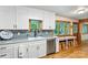Well-lit kitchen with white cabinets, modern appliances, and a view from the window, great for Gathering meals at 8218 Bright Water Ln, Denver, NC 28037
