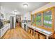 Bright kitchen with stainless steel appliances, wooden floors, and a large window overlooking the lake at 8218 Bright Water Ln, Denver, NC 28037