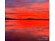 Gorgeous sunrise featuring a beautiful view of the lake with a vibrant red sky and calm water at 8218 Bright Water Ln, Denver, NC 28037