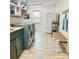 A modern laundry room with a front-load washer and dryer and stylish cabinets at 8218 Bright Water Ln, Denver, NC 28037