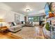 Spacious living room with a brick fireplace, hardwood floors, a comfortable sectional sofa, and lake views at 8218 Bright Water Ln, Denver, NC 28037