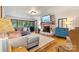 Cozy living room with hardwood floors, a brick fireplace, a comfortable sectional sofa, and natural light at 8218 Bright Water Ln, Denver, NC 28037