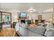 Inviting living room featuring hardwood floors, a brick fireplace, comfortable seating, and a view to a sunroom at 8218 Bright Water Ln, Denver, NC 28037