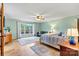 Bright bedroom with large windows, hardwood floors, a seating area, and relaxing color scheme at 8218 Bright Water Ln, Denver, NC 28037
