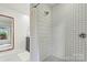 Updated shower with white subway tile and decorative shower curtain at 8218 Bright Water Ln, Denver, NC 28037