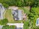 Aerial view of the property showcasing the house, manicured lawns, patio, pool, and surrounding greenery at 8962 Landsdowne Ave, Harrisburg, NC 28075