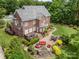 Expansive backyard featuring a deck, patio, fire pit, and lush landscaping at 8962 Landsdowne Ave, Harrisburg, NC 28075