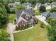 Aerial view of brick two-story home showing large driveway, fenced backyard, and professional landscaping at 8962 Landsdowne Ave, Harrisburg, NC 28075
