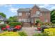 Expansive backyard with a brick patio, outdoor seating, and landscaped gardens, ideal for entertaining guests at 8962 Landsdowne Ave, Harrisburg, NC 28075