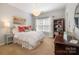 Cozy bedroom with natural light, decorative light fixture, and closet at 8962 Landsdowne Ave, Harrisburg, NC 28075