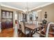 Elegant dining room features dark wood furniture, a chandelier, and archway views at 8962 Landsdowne Ave, Harrisburg, NC 28075