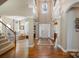 Grand two-story foyer with hardwood floors, elegant columns, and a staircase at 8962 Landsdowne Ave, Harrisburg, NC 28075