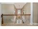 Grand hallway with a staircase, chandelier, and elegant architectural details at 8962 Landsdowne Ave, Harrisburg, NC 28075