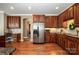 Spacious kitchen featuring stainless steel appliances, granite countertops, and hardwood floors at 8962 Landsdowne Ave, Harrisburg, NC 28075
