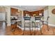 Open kitchen featuring a breakfast bar with modern stools and ample counter space at 8962 Landsdowne Ave, Harrisburg, NC 28075