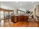 Open kitchen layout with a breakfast bar, stainless steel appliances, and hardwood floors at 8962 Landsdowne Ave, Harrisburg, NC 28075