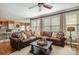 Comfortable living room with a large leather sectional sofa and a ceiling fan at 8962 Landsdowne Ave, Harrisburg, NC 28075