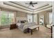 Spacious main bedroom featuring a king bed, tray ceiling, and ample natural light at 8962 Landsdowne Ave, Harrisburg, NC 28075