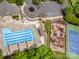 Aerial view of community pool, tennis courts, parking area and clubhouse surrounded by mature trees at 8962 Landsdowne Ave, Harrisburg, NC 28075