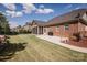 Beautiful brick home featuring a screened porch, patio, and well-maintained lawn at 9026 Raven Top Dr, Mint Hill, NC 28227