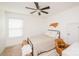 Bedroom features a ceiling fan, natural light, and stylish decor with a wooden state outline at 9026 Raven Top Dr, Mint Hill, NC 28227