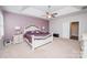 Comfortable bedroom with lavender wall, trey ceiling, white furniture, and bright natural light at 9026 Raven Top Dr, Mint Hill, NC 28227