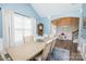 Light-filled dining room features a neutral palette, complementing the adjacent foyer and staircase at 9026 Raven Top Dr, Mint Hill, NC 28227