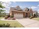 Elegant brick home showcases a well-maintained lawn, complemented by a convenient two-car garage at 9026 Raven Top Dr, Mint Hill, NC 28227