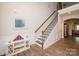 Inviting foyer features hardwood floors, staircase, and decorative mirror, seamlessly blending style and functionality at 9026 Raven Top Dr, Mint Hill, NC 28227